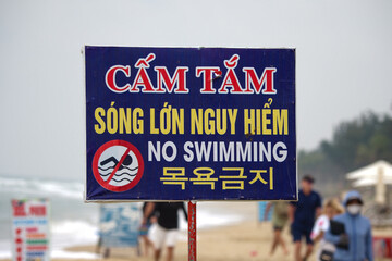 No swimming sign due to high waves, seen at Hoi An beach, Da Nang, Vietnam