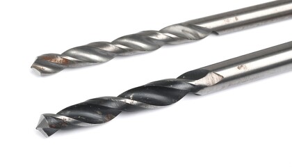 Two metal drill bits, one darker than the other, lie against a white background