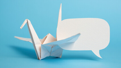 Origami crane unfolding into a speech bubble.