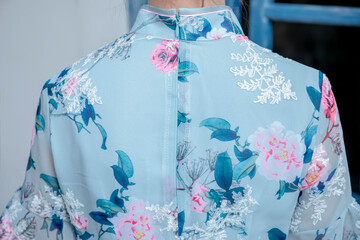 An Asian girl in a blue Tang suit