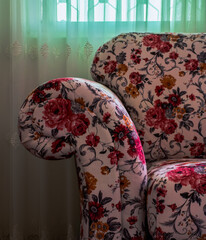 Close-Up of Floral Patterned Upholstered Armchair with Rolled Armrest in Soft Natural Light
