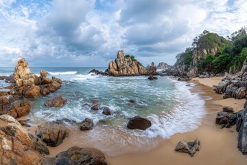 Obraz premium Serene Beach Landscape with Rocky Outcrops and Gentle Waves