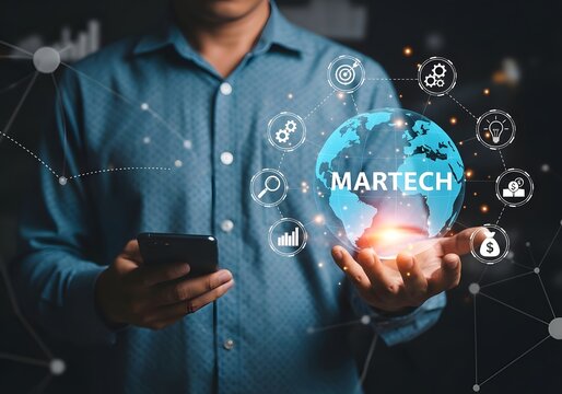 A man holding a globe with martech written on it surrounded by icons and holding a smartphone device