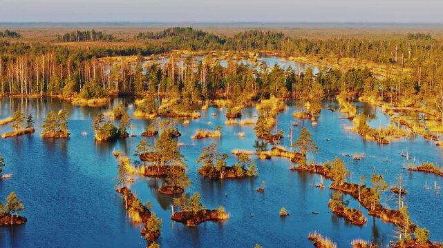 Beautiful sunrise over Kemeri bog with reflections and distant sandy ridges