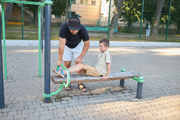 Father and a small son doing a workout session