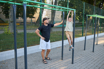Father and a small son doing a workout session