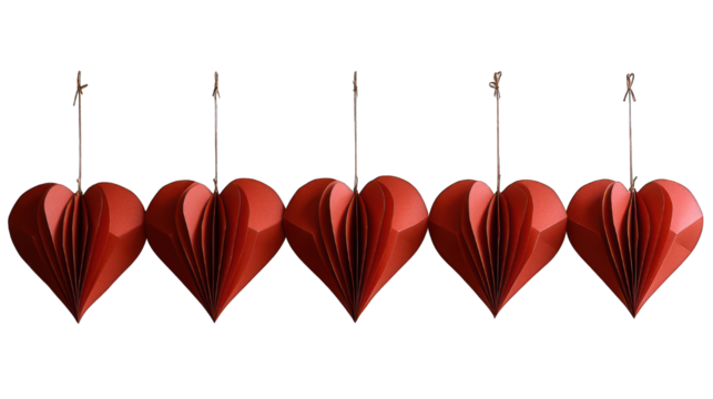 Row of five origami red paper hearts hanging against a black background