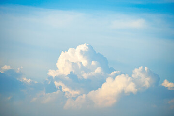 Towering clouds glowing under the soft evening sky
