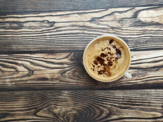 A fresh cup of coffee with cocoa granule as topping. The combination of strong coffee, creamy...