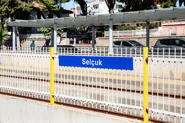 Selcuk train station platform sign and railway tracks in Izmir province, Turkey