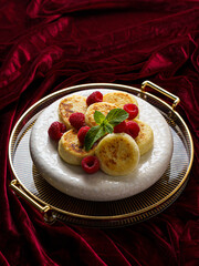 cottage cheese pancakes with raspberries on red velvet