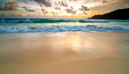 Fototapeta premium Golden Hour Waves: Turquoise Sea Meets Sandy Shore at Sunset