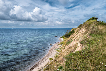 Scenic Coastal Cliffs and Sea View Under a Cloudy Blue Sky, Bjorno, Denmark