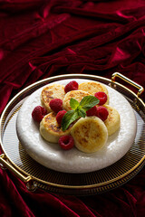 cottage cheese pancakes with raspberries on red velvet
