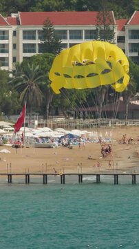 Parachuting In Turkey. Yellow Parasail Wing Pulled By Boat. Sea Summer Recreation. Parasailing With Boat Over Sea In Alanya In Beautiful Summer Day. Holiday Fun Activities. Tropical Paradise