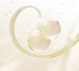 3d gold liquid gel cream blobs with yellow transparent water wave. Fluid flow and oil balls drops with bubbles texture. Cosmetic skincare background. Collagen serum or hyaluronic acid. 3D illustration