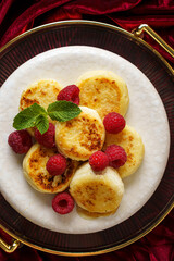 cottage cheese pancakes with raspberries on red velvet