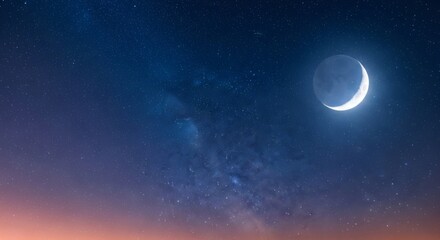 Crescent moon in starry night sky above horizon