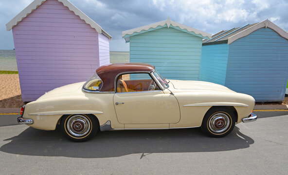 Classic Mercedes-Benz 190 SL  parked in front of beach huts