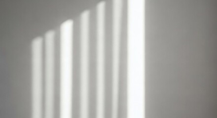 Light and shadow patterns on a white wall