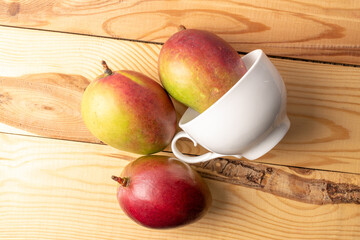 Sweet juicy mangoes on a wooden table, top view, macro.