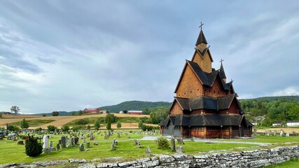 Heddal Stave Church in Telemark Norway. Norse Tradition Medieval Wooden Architecture Featuring Dark Timber Walls, Steep Tiered Roofs, and Intricate Carvings