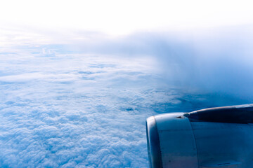 Blue horizon with clouds over the ocean, a view from an airplane window