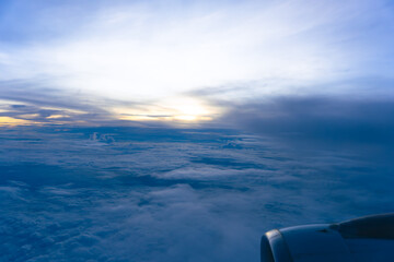 An aerial view of the summer sky and clouds over the ocean at sunset