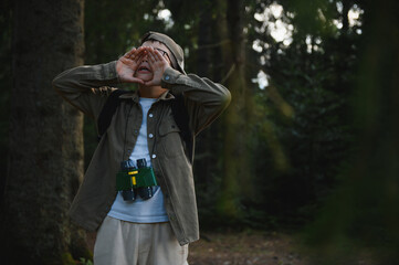 Lost boy scout shouting for help in forest