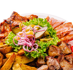 Platter of grilled meats and vegetables served with fresh garnish