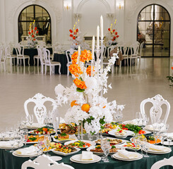 Elegant dining setup with floral centerpieces in a luxurious venue