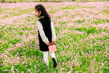 The little Asian girl playing in the garden