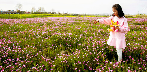 The little Asian girl playing in the garden