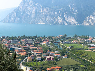 Beautiful panoramic landscape of Torbole on the shores of Lake Garda with surrounding mountains...