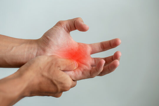Close-up of a hand with red highlighted pain in the palm, symbolizing arthritis, tendonitis, carpal tunnel, or work injury from office syndrome, useful for medical, therapy, and healthcare design.