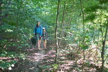 Mother and children hiking in the forest