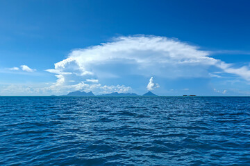 Scenic tropical island with crystal clear turquoise sea and blue sky in Semporna, Sabah, Malaysia.