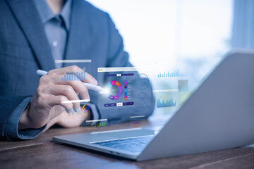 Data analytics dashboard concept with businessman using laptop and digital pen, showing charts,...