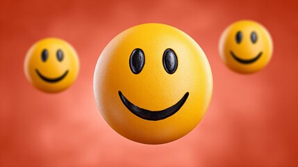 Three yellow smiley faces are floating in the air above a red background. Concept of happiness and positivity, as the smiling faces are the main focus