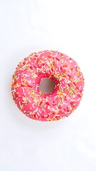 Pink glazed donut with colorful sprinkles on a white background.