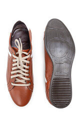 Footwear Ideas. One Pair of Stylish Classic Sportive Male Stylish Brown Polished Laced Shoes Placed Together Sole Upwards Over White.
