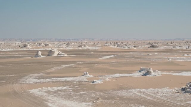 White rock formations and sand dunes in Egypt's White Desert, a natural desert landscape	