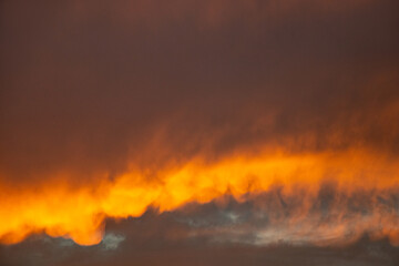 Sunset behind clouds and orange sky with clouds in Ukraine