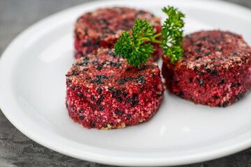 beetroot cutlets in a white plate on a gray background macro
