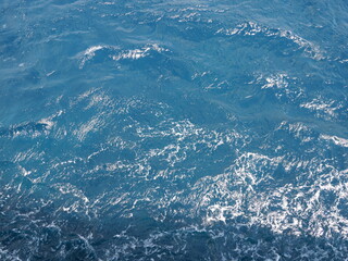 Vivid Photorealistic Pristine Crystal Clear Deep Blue Tropical Ocean Seawater Marine Nature Background Surface. vibrant