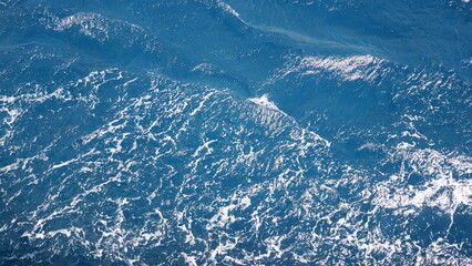 Vivid Photorealistic Pristine Crystal Clear Deep Blue Tropical Ocean Seawater Marine Nature Background Surface. vibrant