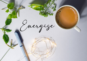 Invigorating Scene with Tea, Greenery, Lights, and Motivational Text