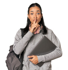 Young Filipino student with laptop keeping a secret or asking for silence.