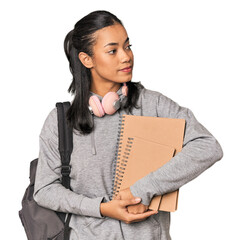 Young Filipino female student with books in studio