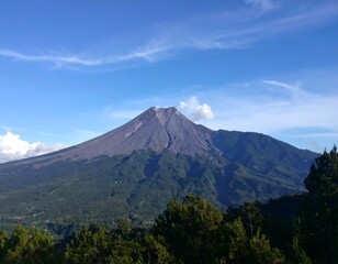 Fototapeta premium Volcano rising above lush forest